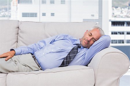 Businessman lying on sofa asleep in the office Photographie de stock - Aubaine LD & Abonnement, Code: 400-06884801