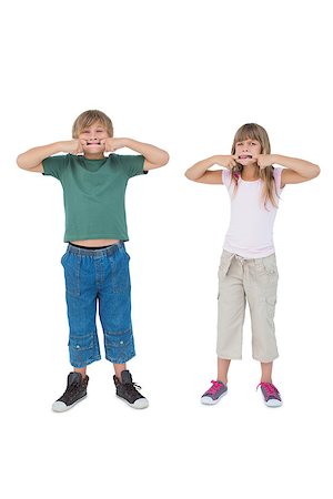 simsearch:400-06885115,k - Funny children pulling faces on white background Photographie de stock - Aubaine LD & Abonnement, Code: 400-06885059