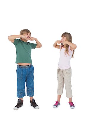 simsearch:400-06885115,k - Funny children pulling faces and looking at each other on white background Photographie de stock - Aubaine LD & Abonnement, Code: 400-06885060