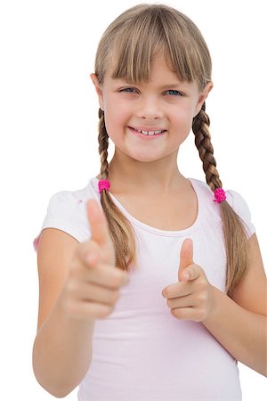 simsearch:400-06885115,k - Pretty blonde girl giving thumbs up and smiling on white background Photographie de stock - Aubaine LD & Abonnement, Code: 400-06885087