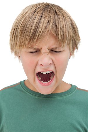 Furious little boy shouting with eyes closed on white background Stock Photo - Budget Royalty-Free & Subscription, Code: 400-06885146