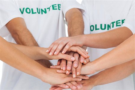 Group of volunteers piling up their hands together Stockbilder - Microstock & Abonnement, Bildnummer: 400-06885196