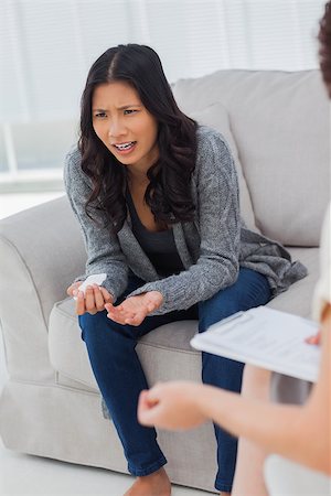 simsearch:6109-08203204,k - Crying woman speaking to her therapist who is taking notes Stock Photo - Budget Royalty-Free & Subscription, Code: 400-06885273