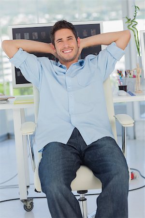 Cheerful creative business employee relaxing on his swivel chair Stock Photo - Budget Royalty-Free & Subscription, Code: 400-06885286