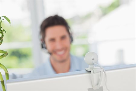 Happy designer having a video chat on his computer Photographie de stock - Aubaine LD & Abonnement, Code: 400-06885296