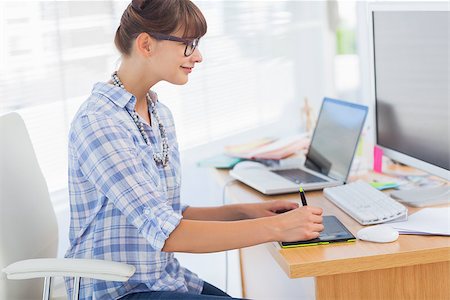 Designer working on her graphics tablet in her office Stock Photo - Budget Royalty-Free & Subscription, Code: 400-06885634