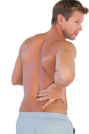 Handsome man suffering from lower back pain on white background Photographie de stock - Aubaine LD & Abonnement, Code: 400-06885757