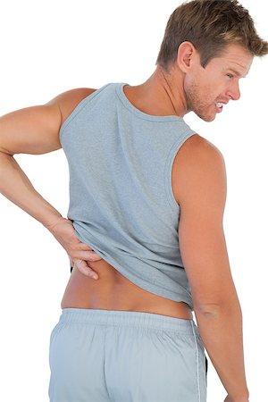 Man grimacing because of a back pain on white background Photographie de stock - Aubaine LD & Abonnement, Code: 400-06885761