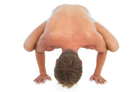 simsearch:400-06885881,k - Man doing a crane pose during a yoga session on white background Photographie de stock - Aubaine LD & Abonnement, Code: 400-06885795