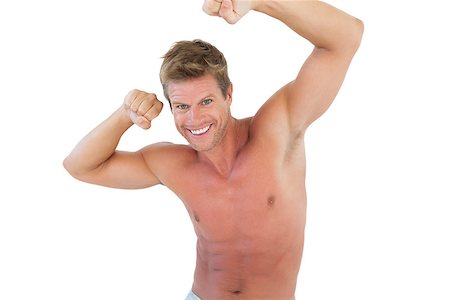 simsearch:400-06885881,k - Smiling man flexing muscles on white background Photographie de stock - Aubaine LD & Abonnement, Code: 400-06885848