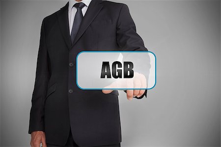 simsearch:400-06886051,k - Businessman selecting tag with agb written on it on grey background Stock Photo - Budget Royalty-Free & Subscription, Code: 400-06885910