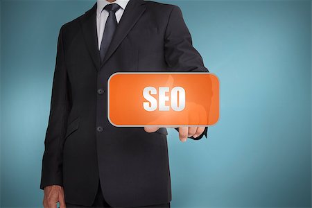 simsearch:400-06886821,k - Businessman selecting orange tag with the word seo written on it on blue background Photographie de stock - Aubaine LD & Abonnement, Code: 400-06885930