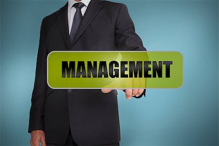 simsearch:400-06886821,k - Businessman touching the word management written on green tag on blue background Photographie de stock - Aubaine LD & Abonnement, Code: 400-06885978