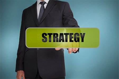 simsearch:400-06886798,k - Businessman touching the word strategy written on green tag on blue background Stock Photo - Budget Royalty-Free & Subscription, Code: 400-06885981