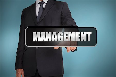 simsearch:400-06886798,k - Businessman touching the word management written on black tag on blue background Stock Photo - Budget Royalty-Free & Subscription, Code: 400-06886004