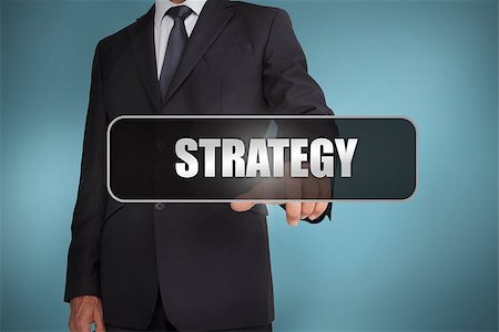 simsearch:400-06886798,k - Businessman touching the word strategy written on black tag on blue background Stock Photo - Budget Royalty-Free & Subscription, Code: 400-06886007