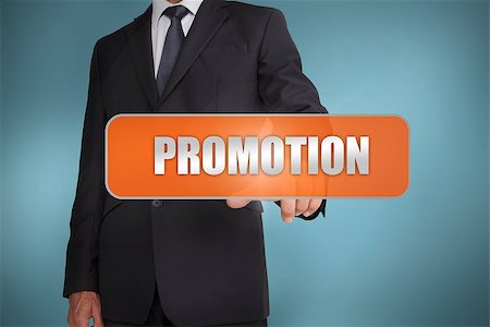 Businessman selecting the word promotion written on orange tag on blue background Stock Photo - Budget Royalty-Free & Subscription, Code: 400-06886015