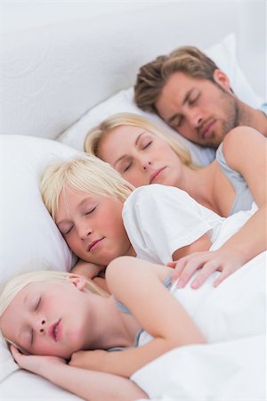 simsearch:400-06930138,k - Couple sleeping with their children in bed Stock Photo - Budget Royalty-Free & Subscription, Code: 400-06886574