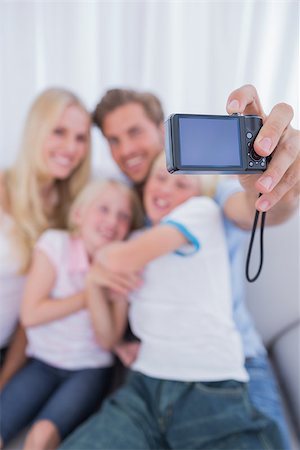 simsearch:400-06930138,k - Father taking picture of his family in the living room Stock Photo - Budget Royalty-Free & Subscription, Code: 400-06886630