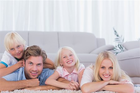 simsearch:400-06930138,k - Smiling family lying on the carpet at home Stock Photo - Budget Royalty-Free & Subscription, Code: 400-06886657