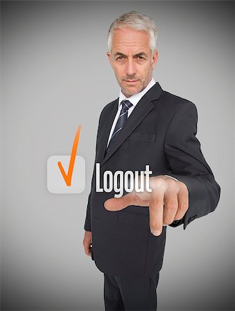 Businessman selecting the word logout next to a ticked box Stock Photo - Budget Royalty-Free & Subscription, Code: 400-06886786