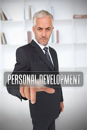 simsearch:400-06886051,k - Businessman touching the term personal development in front of a bookcase Stock Photo - Budget Royalty-Free & Subscription, Code: 400-06886804