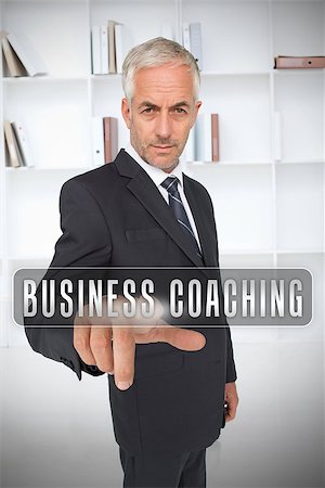 simsearch:400-06886789,k - Businessman selecting the term business coaching in front of a bookcase Photographie de stock - Aubaine LD & Abonnement, Code: 400-06886808