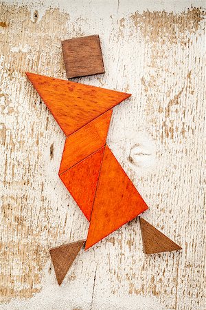 simsearch:400-07774007,k - abstract figure of a female dancer built from seven tangram wooden pieces, a traditional Chinese puzzle game; rough white painted barn wood background Foto de stock - Royalty-Free Super Valor e Assinatura, Número: 400-06886949