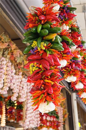 Colorful Hot Chili Jalapeno and Cayenne Peppers and Garlic Bunches Hanging at Fruits and Vegetable Stall Stock Photo - Budget Royalty-Free & Subscription, Code: 400-06887229
