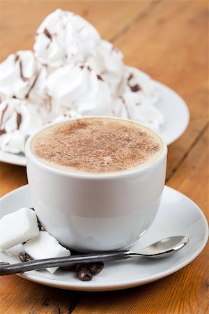 Cup of cappuccino with foam and meringues on white plate Foto de stock - Super Valor sin royalties y Suscripción, Código: 400-06887352