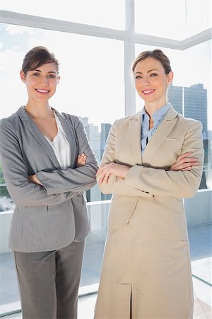 simsearch:400-07275828,k - Confident businesswomen smiling at camera with arms crossed Photographie de stock - Aubaine LD & Abonnement, Code: 400-06887839