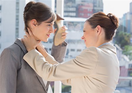 strangle women - Businesswoman strangling another in the office Stock Photo - Budget Royalty-Free & Subscription, Code: 400-06887858