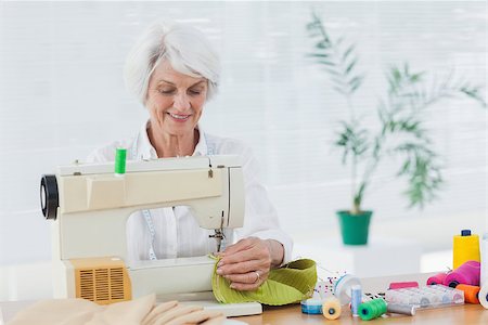 Retired woman using the sewing machine at home Stock Photo - Budget Royalty-Free & Subscription, Code: 400-06888257