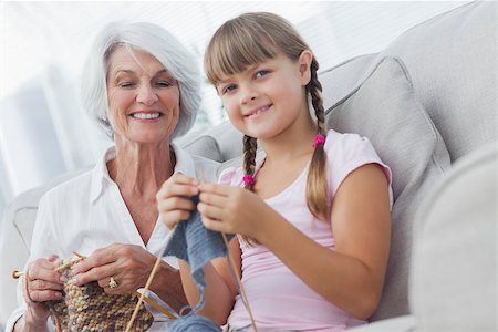 Young girl and her granddaughter knitting together in the living room Stock Photo - Budget Royalty-Free & Subscription, Code: 400-06888272