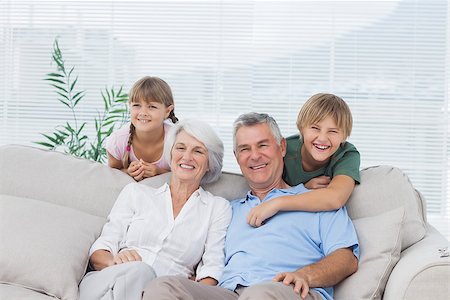 family sitting room sofa grandparents - Grandchildren and grandparents sitting on couch in living room Stock Photo - Budget Royalty-Free & Subscription, Code: 400-06888285
