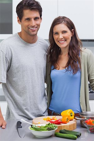 piment - Cheerful couple smiling at camera and preparing vegetables in their kitchen Stockbilder - Microstock & Abonnement, Bildnummer: 400-06888323