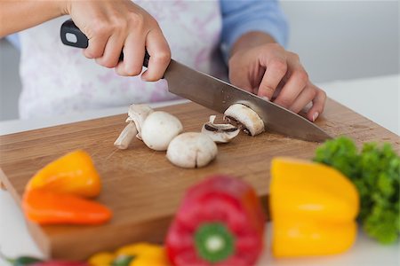 simsearch:400-06891385,k - Woman slicing mushrooms on a wooden board Stock Photo - Budget Royalty-Free & Subscription, Code: 400-06888451