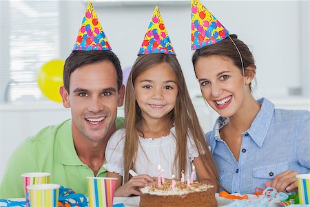 Parents celebrating their little girls birthday with a birthday cake Stock Photo - Budget Royalty-Free & Subscription, Code: 400-06888512