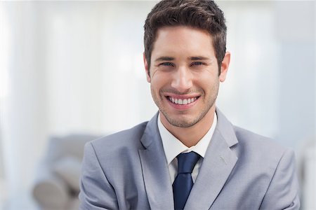 sophisticated home smile - Handsome businessman standing in the living room Stock Photo - Budget Royalty-Free & Subscription, Code: 400-06888700