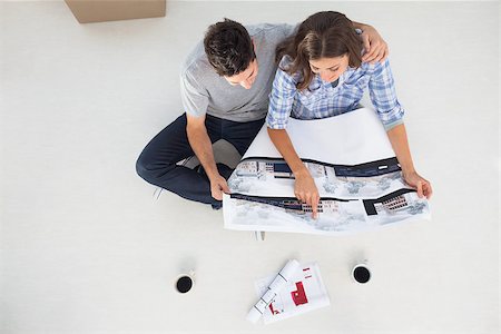 Overview of a husband and his wife looking at house plans sitting in their new house Stock Photo - Budget Royalty-Free & Subscription, Code: 400-06888746
