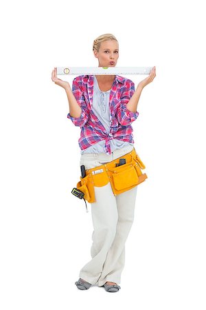 Blonde woman standing holding a spirit level on white background Stock Photo - Budget Royalty-Free & Subscription, Code: 400-06888880