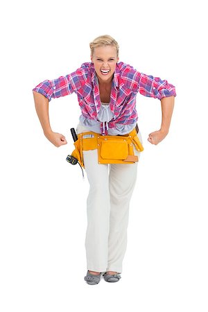 Blonde woman tensing arms wearing tool belt on white background Stock Photo - Budget Royalty-Free & Subscription, Code: 400-06888894