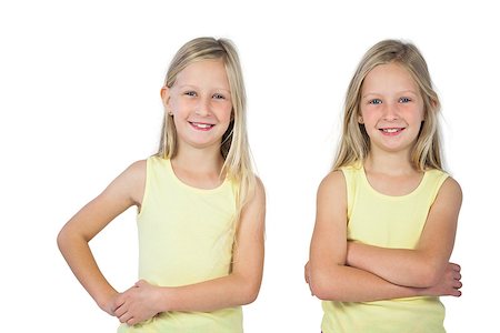 Smiling girls with arms crossed on a white background Stock Photo - Budget Royalty-Free & Subscription, Code: 400-06889016