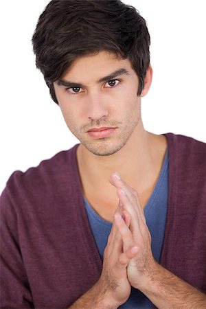 simsearch:400-06889146,k - Upset young man with hands together on a white background Foto de stock - Super Valor sin royalties y Suscripción, Código: 400-06889046