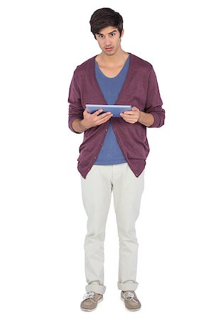 simsearch:400-06889355,k - Young man with tablet pc looking at the camera on a white background Stockbilder - Microstock & Abonnement, Bildnummer: 400-06889054