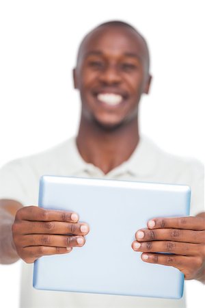 simsearch:400-06889355,k - Tablet pc held by smiling man on white background Stockbilder - Microstock & Abonnement, Bildnummer: 400-06889357