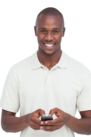 simsearch:400-06889355,k - Smiling man using his mobile phone on a white background Stockbilder - Microstock & Abonnement, Bildnummer: 400-06889359