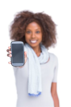 scarf curly woman - Cheerful woman showing her smartphone on white background Stock Photo - Budget Royalty-Free & Subscription, Code: 400-06880028