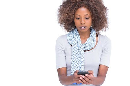 scarf curly woman - Concentrated woman typing a text message on white background Stock Photo - Budget Royalty-Free & Subscription, Code: 400-06880023