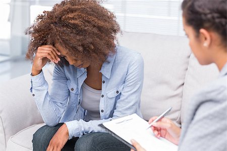 simsearch:6109-08203204,k - Woman sitting on sofa and crying with therapist taking notes Stock Photo - Budget Royalty-Free & Subscription, Code: 400-06880051